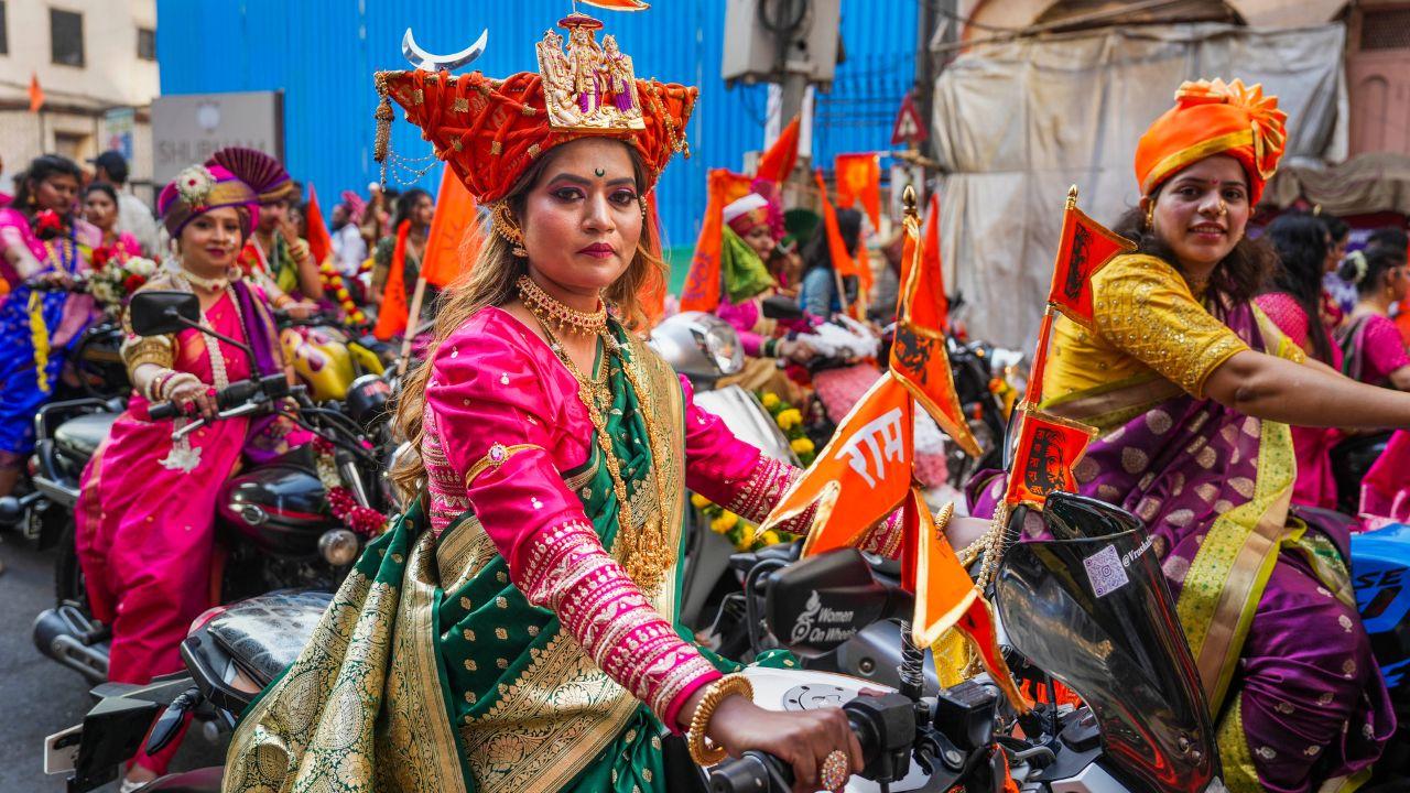 Another woman from the Girgaon bike rally looks stunning in the traditional Maharashtrian outfit. The chandrakor (bindi) and Maratha turban elevate her overall look. (PTI Photo/Kunal Patil)